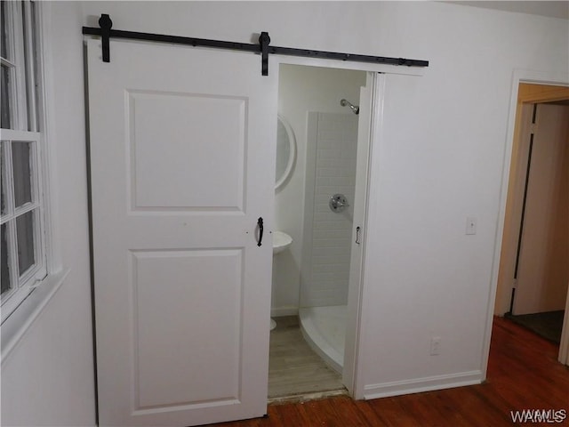 bathroom with a shower and hardwood / wood-style floors