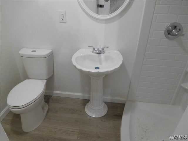 bathroom with walk in shower, wood-type flooring, and toilet