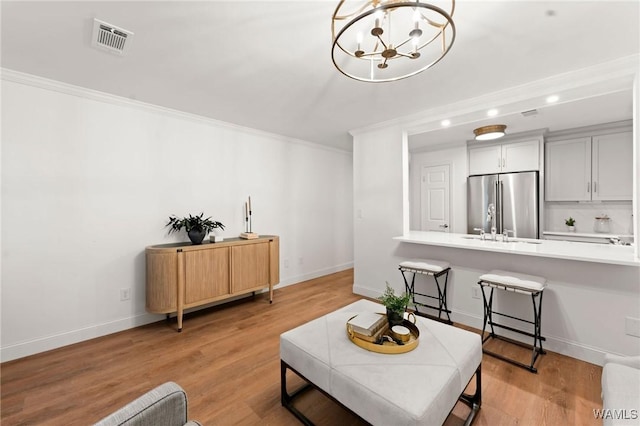 1228 8th St Unit 412, Tuscaloosa, AL 35401 - living area featuring ornamental molding, a chandelier, recessed lighting, and light wood-style floors