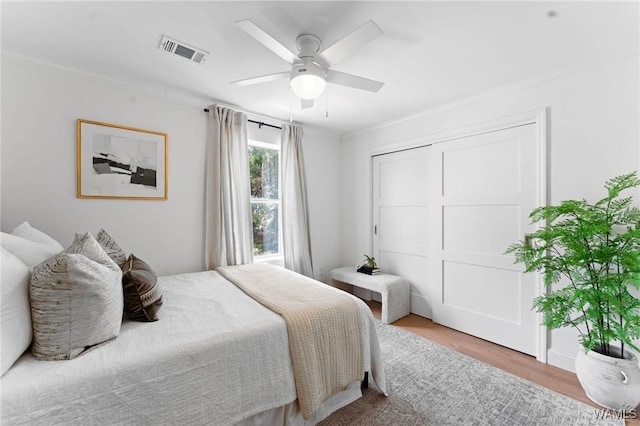 1228 8th St Unit 412, Tuscaloosa, AL 35401 - bedroom featuring wood finished floors, ornamental molding, and a ceiling fan