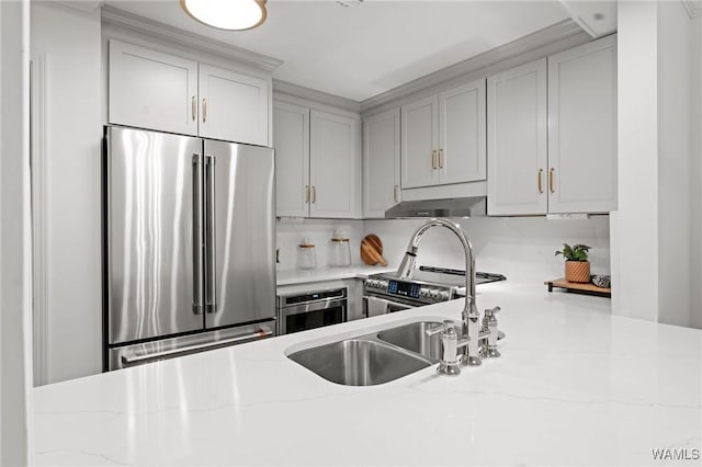 1228 8th St Unit 412, Tuscaloosa, AL 35401 - kitchen with stainless steel appliances, under cabinet range hood, backsplash, and light stone counters
