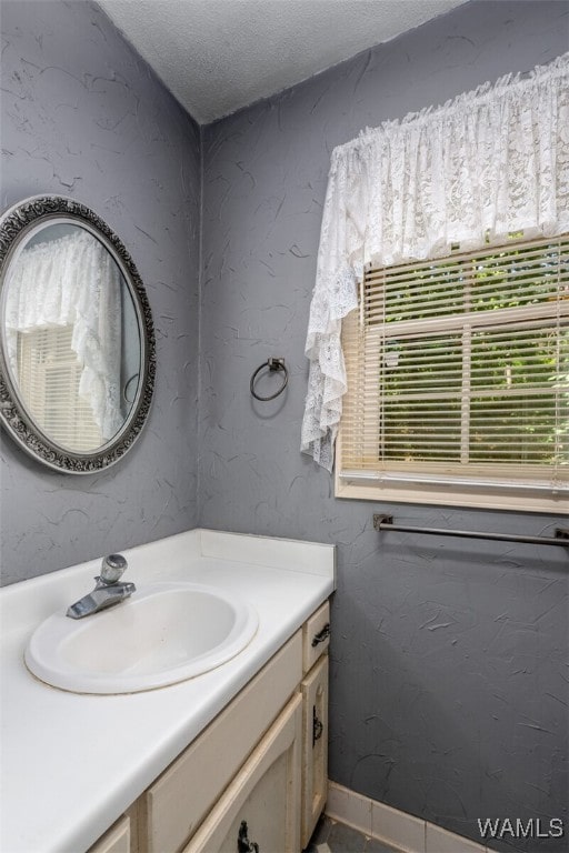 bathroom with vanity and a textured ceiling