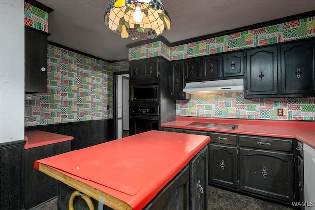 kitchen featuring cooktop, a textured ceiling, crown molding, oven, and stainless steel microwave