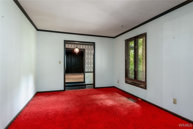 carpeted spare room with crown molding