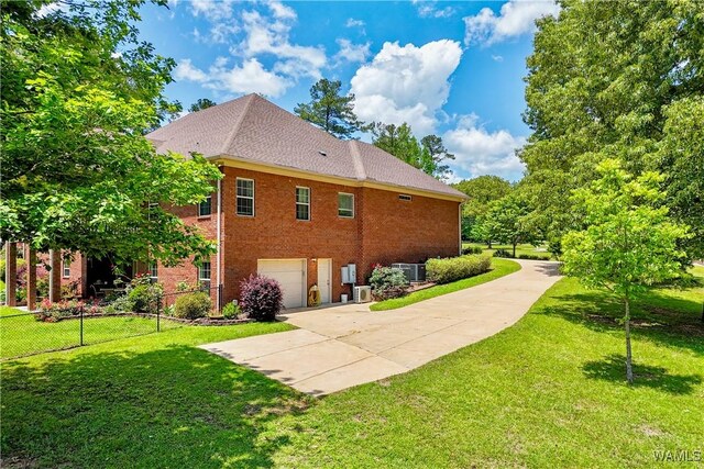 392 Fawn Ln, Centreville, AL 35042 - view of side of home featuring a garage, brick siding, driveway, and central AC unit