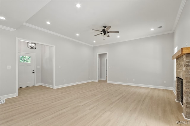 unfurnished living room featuring ceiling fan with notable chandelier, crown molding, light wood-type flooring, and a fireplace