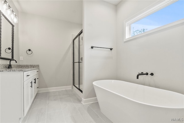 bathroom with vanity and independent shower and bath