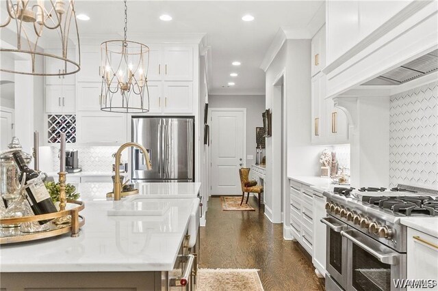 6020 Carleton Park Cir, Tuscaloosa, AL 35406 - kitchen with stainless steel appliances, custom range hood, white cabinetry, dark wood-style floors, and hanging light fixtures