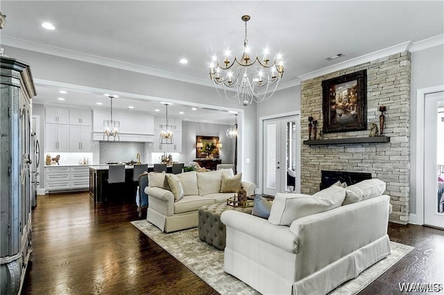 6020 Carleton Park Cir, Tuscaloosa, AL 35406 - living area with a chandelier, dark wood-style flooring, a stone fireplace, recessed lighting, and ornamental molding