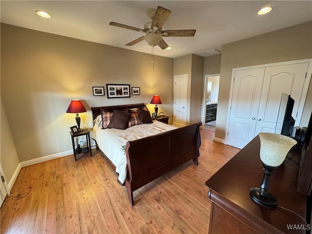 bedroom with ceiling fan and light hardwood / wood-style floors