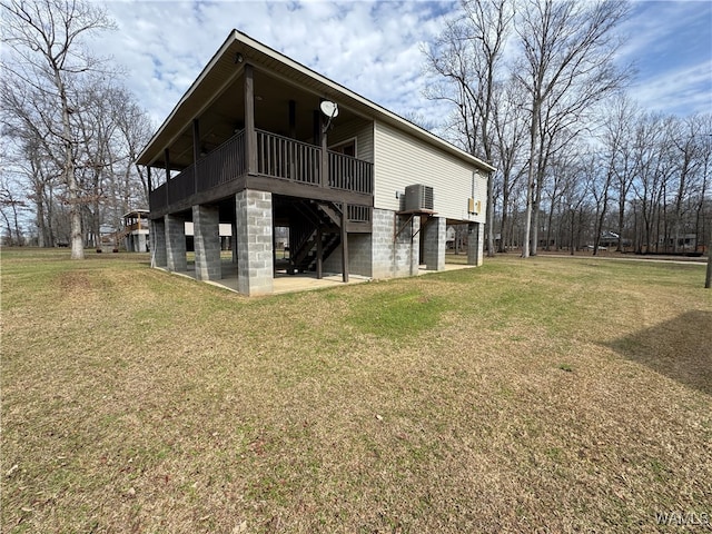 rear view of house with central AC, a patio, a deck, and a lawn