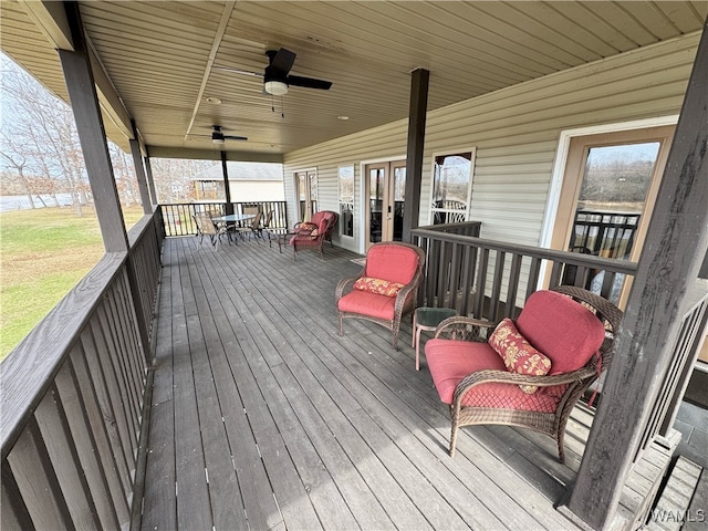 wooden deck featuring ceiling fan