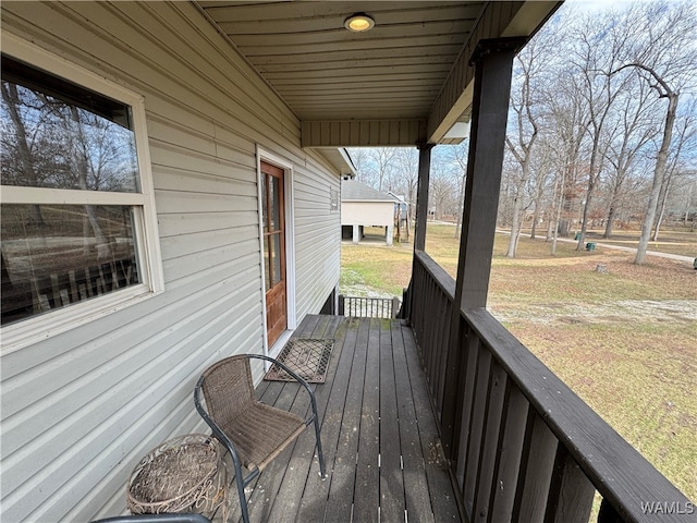 wooden deck featuring a lawn