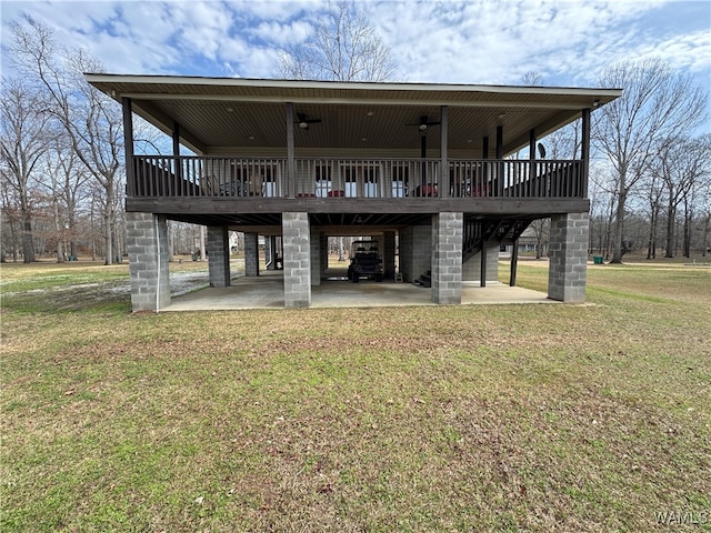 rear view of property featuring a patio, a yard, and a deck