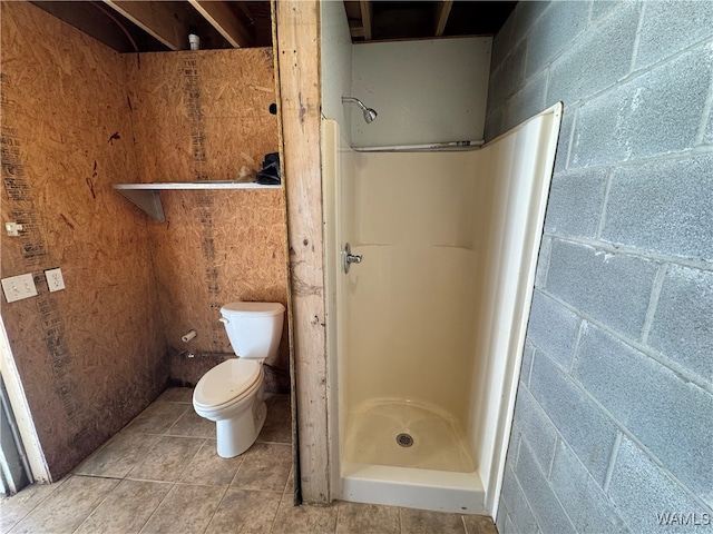 bathroom with a shower, tile patterned floors, and toilet