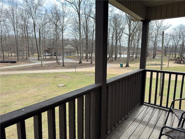 wooden deck featuring a lawn