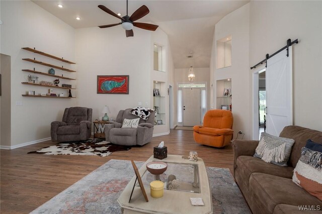1606 Mallard Cir, Tuscaloosa, AL 35405 - living area featuring high vaulted ceiling, wood finished floors, a barn door, a ceiling fan, and baseboards