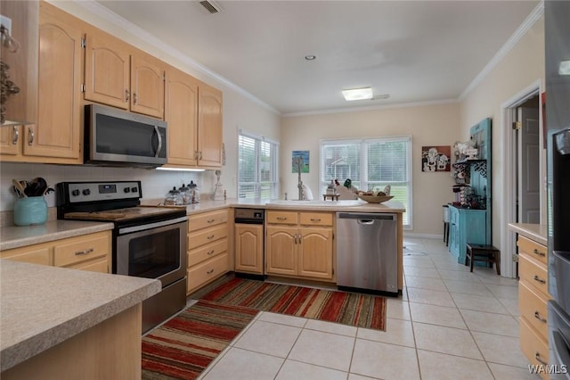 1606 Mallard Cir, Tuscaloosa, AL 35405 - kitchen featuring stainless steel appliances, light brown cabinetry, a peninsula, ornamental molding, and light tile patterned floors