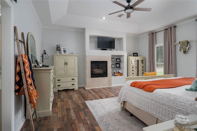 1606 Mallard Cir, Tuscaloosa, AL 35405 - bedroom with a raised ceiling, dark wood-type flooring, a glass covered fireplace, baseboards, and ornamental molding