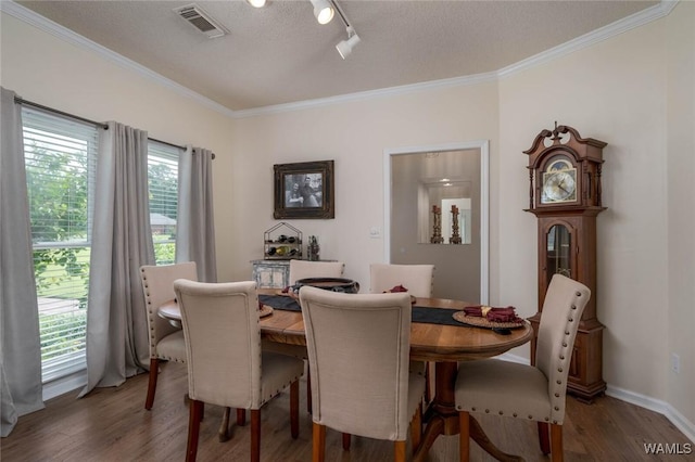 1606 Mallard Cir, Tuscaloosa, AL 35405 - dining area with ornamental molding, wood finished floors, rail lighting, and baseboards