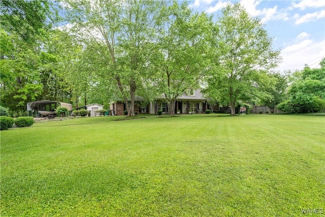 view of yard featuring a carport and a porch