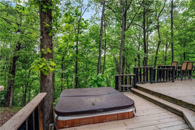 wooden deck featuring a covered hot tub