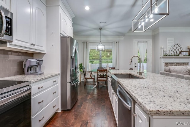 13782 Highland Pointe Dr, Northport, AL 35475 - kitchen with appliances with stainless steel finishes, a sink, crown molding, dark wood-style flooring, and backsplash