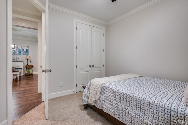 13782 Highland Pointe Dr, Northport, AL 35475 - bedroom featuring ornamental molding, a closet, baseboards, carpet floors, and wood finished floors
