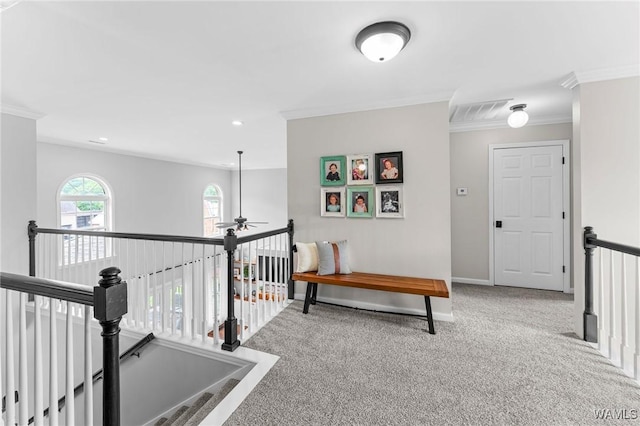 hall featuring an upstairs landing, ornamental molding, carpet flooring, baseboards, and recessed lighting