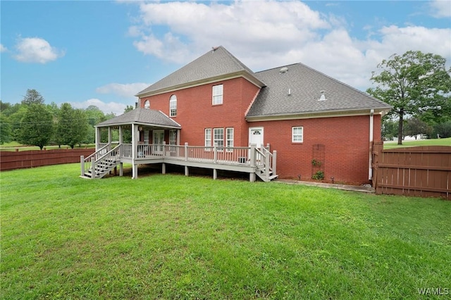 back of house with a gazebo, a wooden deck, a shingled roof, and brick siding