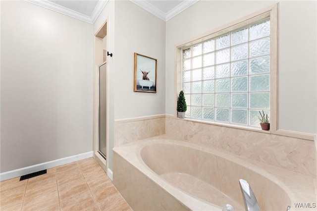 bathroom with a shower stall, a bath, crown molding, and tile patterned floors