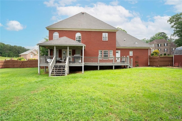 back of house featuring a deck, brick siding, and roof with shingles