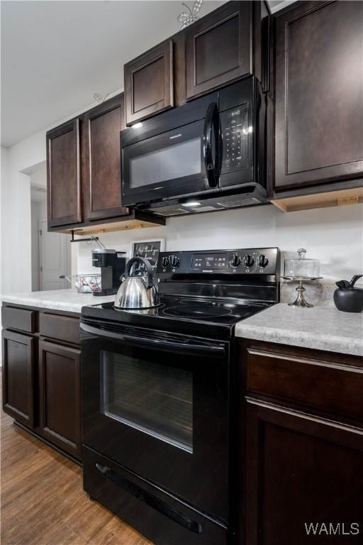 11621 Cedar Glades Dr, Vance, AL 35490 - kitchen featuring black appliances, dark brown cabinetry, light countertops, and wood finished floors