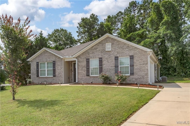 11621 Cedar Glades Dr, Vance, AL 35490 - ranch-style house with brick siding, central AC unit, a front yard, and concrete driveway