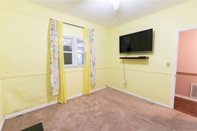 empty room with carpet floors, ceiling fan, and ornamental molding