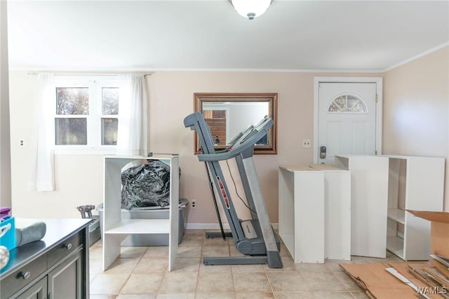 workout area featuring light tile patterned floors and crown molding