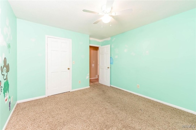 unfurnished bedroom with ceiling fan and carpet floors