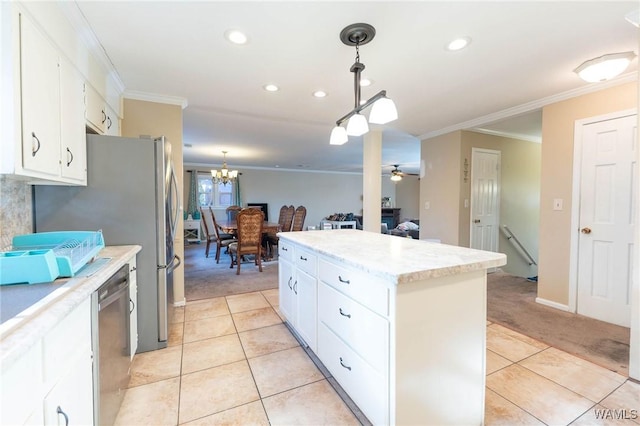 kitchen featuring a kitchen island, stainless steel dishwasher, light colored carpet, white cabinets, and ceiling fan with notable chandelier