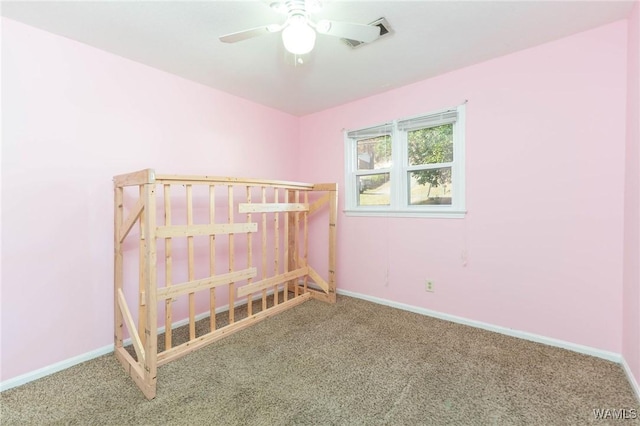 unfurnished bedroom featuring ceiling fan and carpet