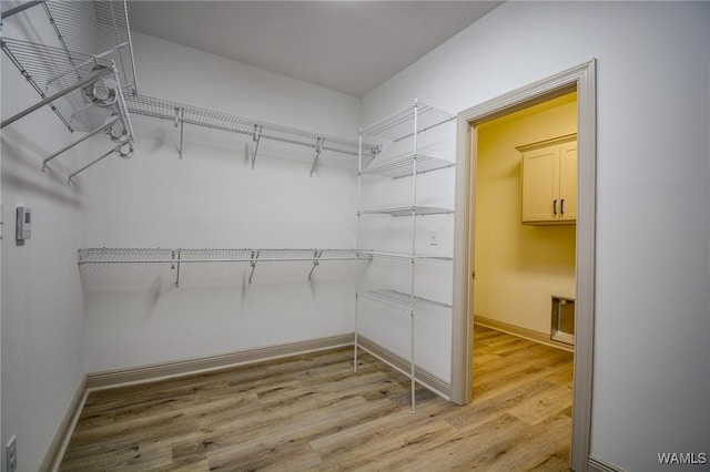 spacious closet featuring light wood-type flooring