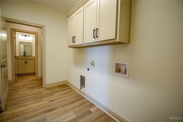 clothes washing area with cabinet space, light wood finished floors, baseboards, hookup for an electric dryer, and washer hookup