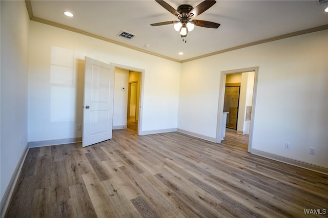 unfurnished bedroom with visible vents, crown molding, baseboards, and wood finished floors