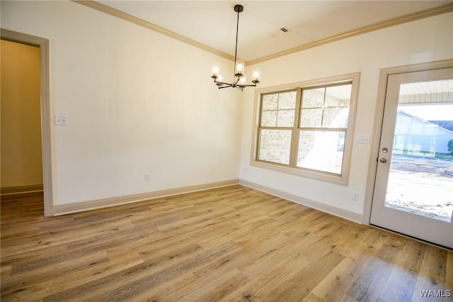 unfurnished dining area featuring light wood finished floors, baseboards, ornamental molding, and an inviting chandelier