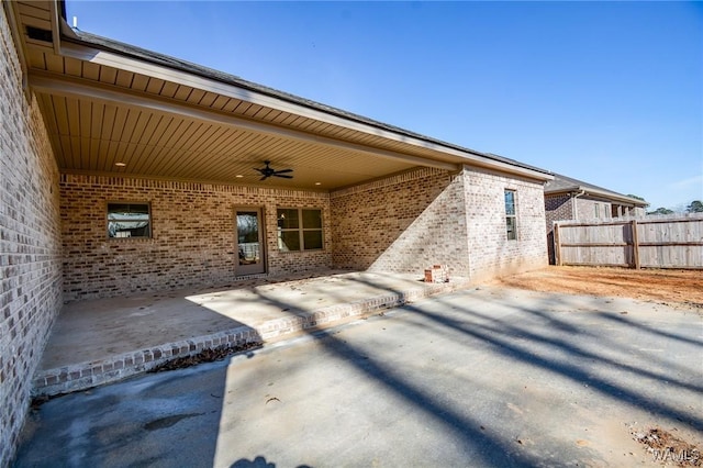 view of patio featuring ceiling fan and fence