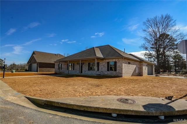 view of front of house featuring covered porch and brick siding