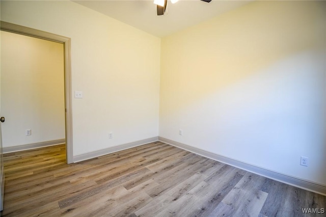 unfurnished room with a ceiling fan, baseboards, and wood finished floors