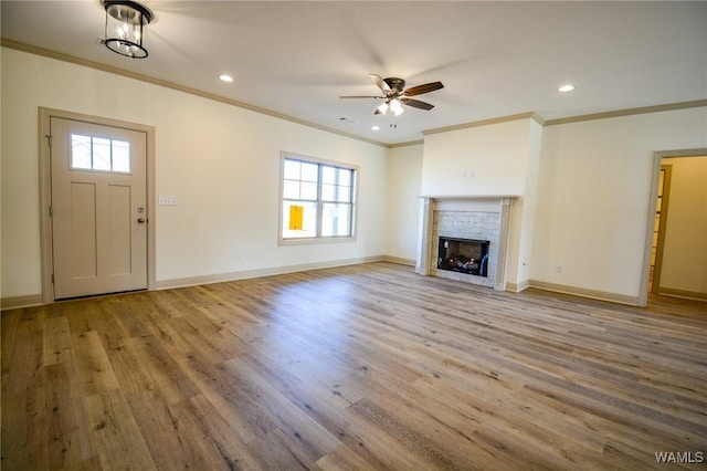 unfurnished living room with recessed lighting, a fireplace, wood finished floors, and baseboards