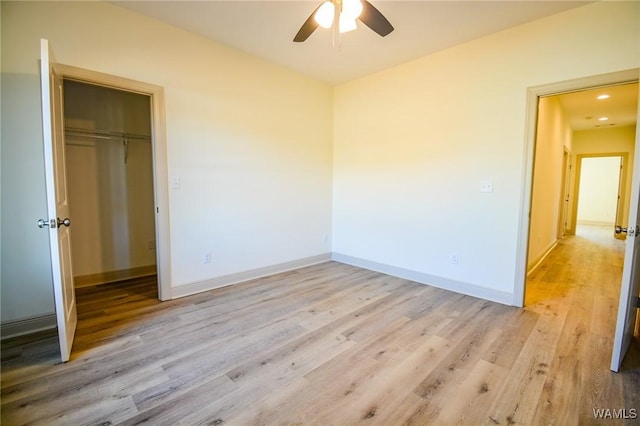 unfurnished bedroom with light wood-style floors, a closet, and baseboards