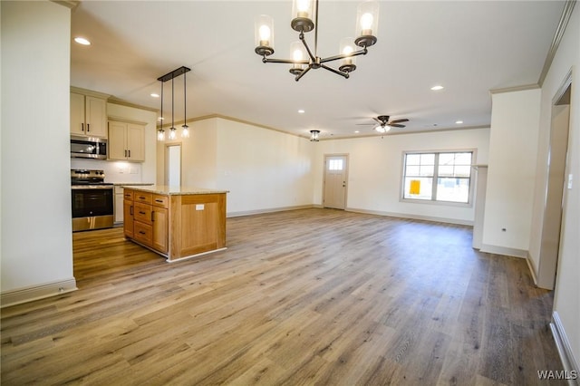 kitchen featuring stainless steel appliances, baseboards, open floor plan, ornamental molding, and light wood finished floors