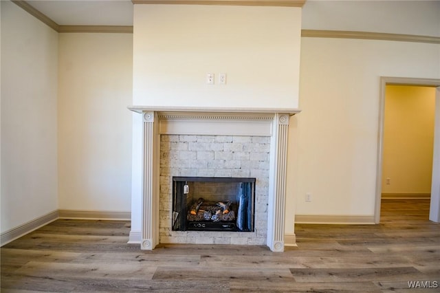 interior details featuring a fireplace, wood finished floors, and baseboards